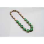 Jadeite unmarked rose gold line bracelet, comprising ten oval cabochon cut green jadeite, dimensions