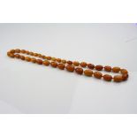 Butterscotch amber type graduated bead necklace, comprising thirty-seven oval beads ranging in