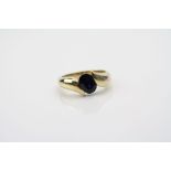 Sapphire yellow metal ring, the oval mixed cut blue sapphire measuring approximately 8mm x 5.5mm,