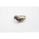 Ruby and diamond 18ct yellow gold ring, eight graduated mixed cut rubies and thirteen small round