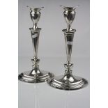 Pair of silver candlesticks, urn shaped capital with removable sconce, tapered knopped and reeded