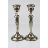 Pair of silver candlesticks, tapered stems raised on moulded circular feet with bead detailing,