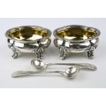 Pair of Victorian silver salt cellars, plain polished body raised on four feet with scroll detail