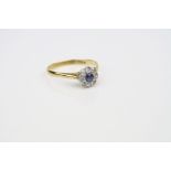 Sapphire and diamond 18ct yellow gold platinum set flower head ring, the central round mixed cut