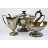 Edwardian silver three piece tea service comprising pedestal teapot, swing handled sugar bowl and