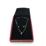 Ruby and diamond 18ct white gold suit comprising pendant necklace and stud earrings, the oval