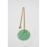 Jade 9ct yellow gold pendant necklace, the carved jade panel with floral decoration, diameter