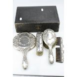 Early 20th century four piece silver backed dressing table brush set, comprising hand mirror,