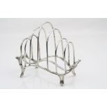 George VI silver seven bar toast rack, boat shaped form raised on four feet with scroll detailing