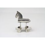 Simplistic silver figure of a toy horse, on wheels, sodalite cabochon to tailpiece, possibly