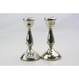 Pair of silver dwarf candlesticks, inverted bell shaped scones, baluster stems to moulded circular