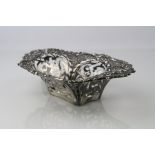 Edwardian silver bon bon dish, pierced foliate scroll body with repoussé floral decoration, makers