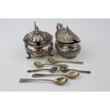 Silver mustard pot raised on three feet, shell shoulders, cast shell design border, hinged lid,
