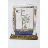 White metal filigree stylised model of a boat, bird head figurehead, height approximately 20cm,