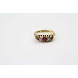 Edwardian ruby and diamond 18ct yellow gold boat head ring, three round mixed cut synthetic rubies