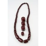 Cherry amber Bakelite necklace, forty-eight graduated barrel shaped beads, the smallest bead