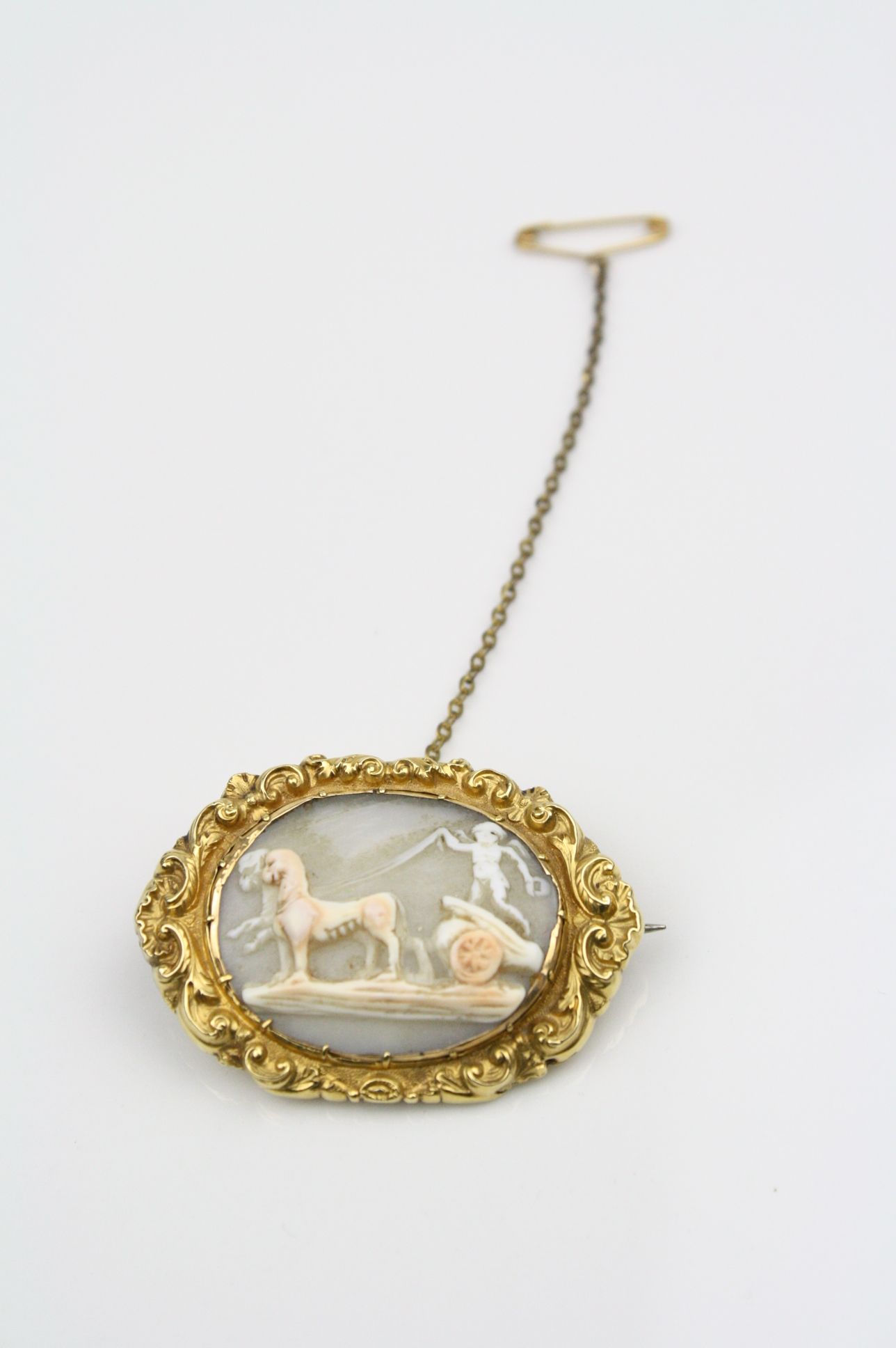 Victorian shell cameo yellow metal brooch, the cameo depicting a cherub driving chariot and