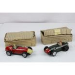 Two early tin plate Scalextric racing slot cars both with drivers, one red (driver missing one
