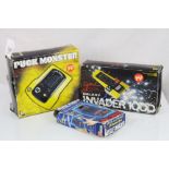 A collection of three vintage boxed handheld electronic games to include Puck Monster, Galaxy