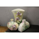 Three Franz Ceramic Vases, two with moulded Iris's and the other with Violets, largest 31cms high