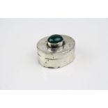 Sterling silver pill box set with cabochon green stone to the top, stamped 925 tothe base.