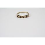 A 9ct yellow gold ruby and diamond set half eternity ring.