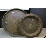 Two Large Indian Brass Trays, one engraved with a scene of the Taj Mahal 58cms diameter, the other