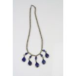 A ladies white metal Lapis Lazuli drop necklace.