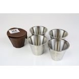 A set of four vintage stirrup cups within a leather case.