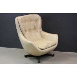 Mid 20th century Retro Swivel Egg Chair upholstered in Cream Leatherette raised on a Teak ' X '