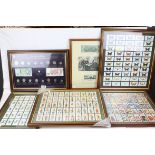 A collection of framed and glazed coins, banknotes and cigarette cards.