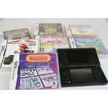 A Nintendo DS handheld games console together with a selection of games.