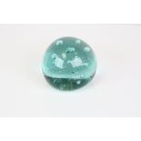 A vintage glass dump paperweight