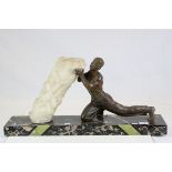 Art Deco Spelter Figure of a Strong Man lifting a Rock held on a Black Marble Plinth, 69cms long x