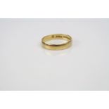 A 18ct yellow gold wedding band ring.