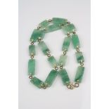 A Jade necklace, bracelet, ring and pendant set.