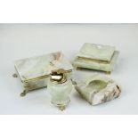 A collection of green onyx smoking related items to include cigarette boxes, ashtray and lighter.