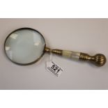Large brass hand held magnifying glass with mother of pearl handle