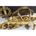 Two Gilt Wooden Hanging Shelves, longest 65cms together with a Gilt Wooden Wreath and another
