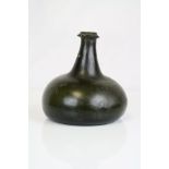 An antique 18th century green glass onion bottle.