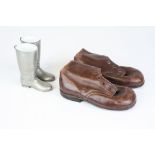 A pair of vintage children's boots together with a pair of boot shaped stirrup cups.