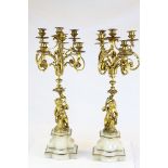 A pair of French gilt metal six branch chandeliers, probably late 19th century, supported by putti