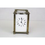 A brass cased carriage clock with white enamel dial.