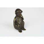 A bronze oriental cricket cage in the form of a seated stylised monkey.