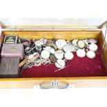 A collection of antique and vintage watches, pocket watches and travel clocks within a wooden