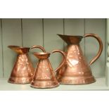 Three Antique Copper Graduating Measuring Jugs marked 1/2 Gall, 1/4 Gall and 1/8 Gall