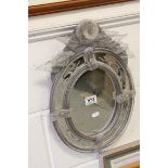 Venetian Style Glass Oval Mirror with etched mirrored frame and surmounted by floral detail (a/f),