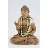 South East Asian Wooden Carving of a Seated Buddha wearing a bead necklace, 27cms high