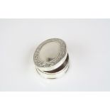 Silver pill box with blank cartouche the interior enamel set in the woodhall style