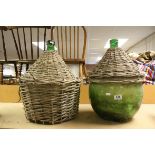 Two Large Green Glass Carboy Bottles, one contained within a Wicker Basket and the other with Two